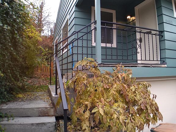 Entry with newly re-poured stairs and iron railings