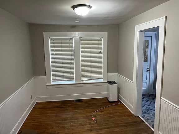 Dining Room with big windows looking out to the wooded back yard