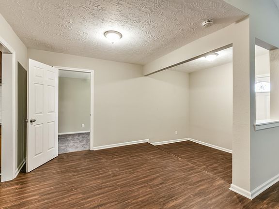 Large entry space leading into dining room, kitchen, and secondary bedroom.
