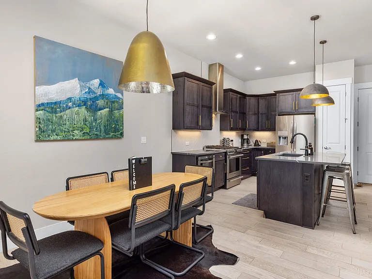 Dining area and kitchen (furniture pictured is for staging purposes only - unfurnished unit)