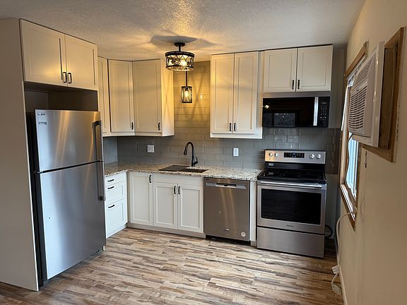 Completely remodeled kitchen including new cabinets, stainless steel appliances, backsplash, lighting, flooring and paint.