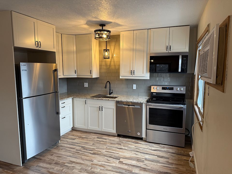 Completely remodeled kitchen including new cabinets, stainless steel appliances, backsplash, lighting, flooring and paint.