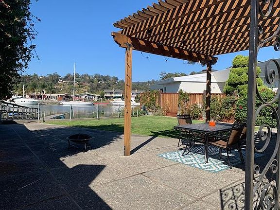 Patio view to the canal- awesome outside dining with shade awning. Direct access outside from kitchen/family room through sliding glass doors.