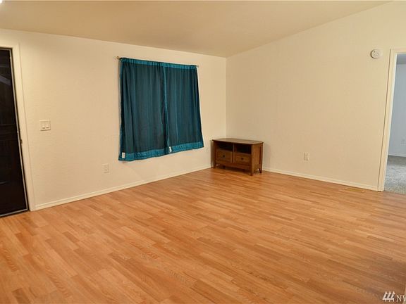 Living room, with screen door and covered entry/front deck.