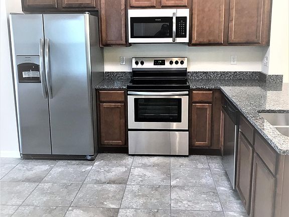 Kitchen with Stainless steel appliances + Tile flooring