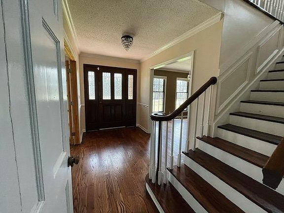 Entryway, to the left is study, right is dining and stairs