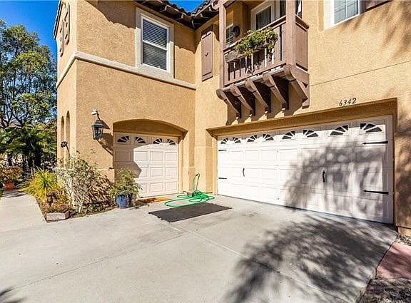 Side elevation view to the third car garage and 1 bedroom apartment on the top with balcony