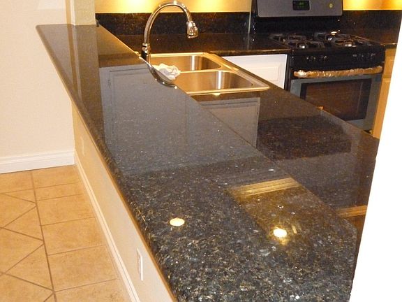 Designer kitchen with stainless appliances and granite.