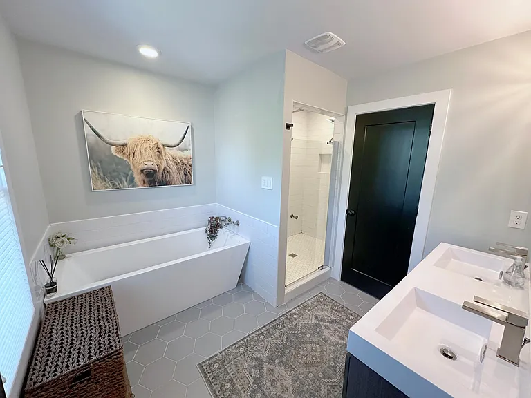 Master Bath with double vanity, soaking tub and enclosed toilet room.