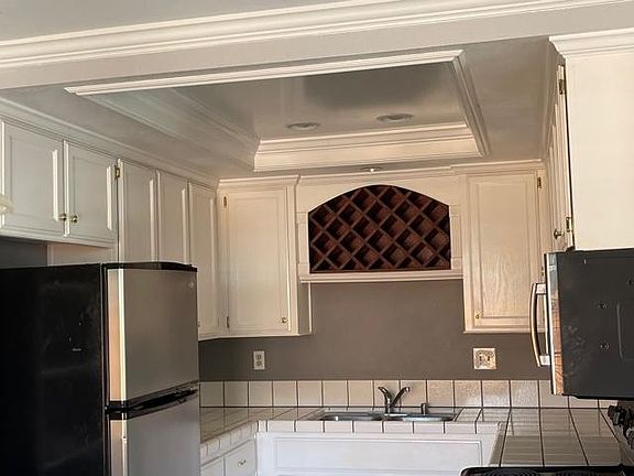 Kitchen with refrigerator and microwave.
