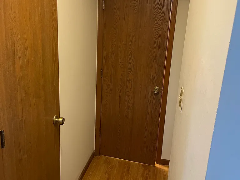 hallway to closet, 1/2 bath and door to garage