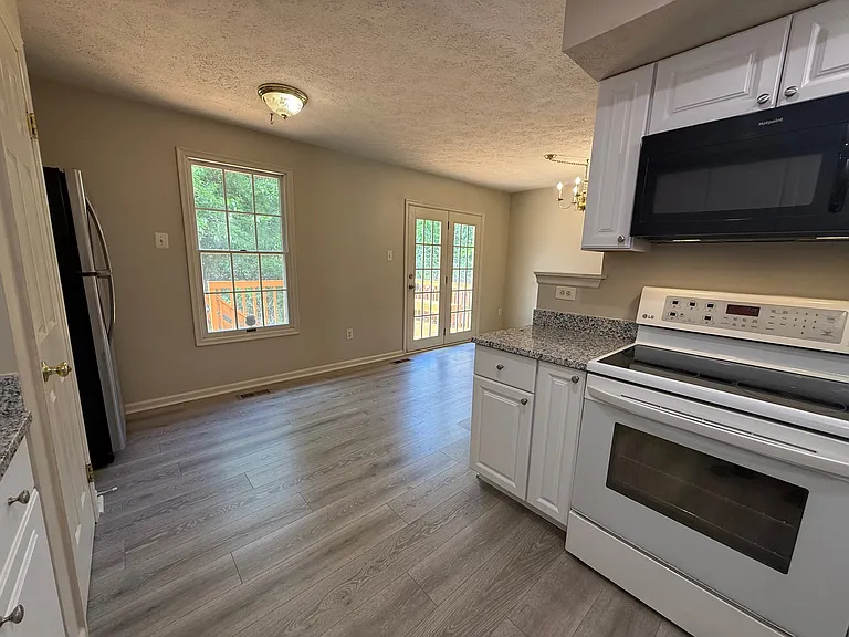 Dining room with patio door leading to deck and woods