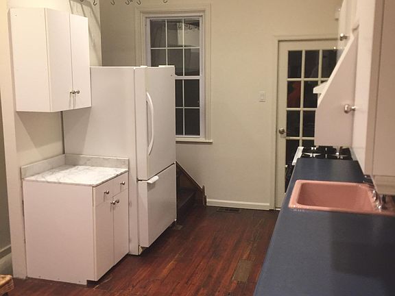 Large fridge with pastry nook in marble and pot rack.