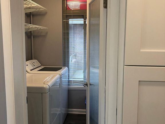 Full size washer and dryer plus storage.