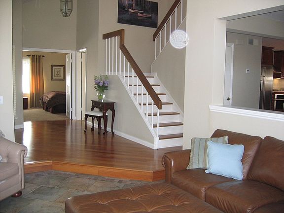 Foyer with hardwood floors and stairs