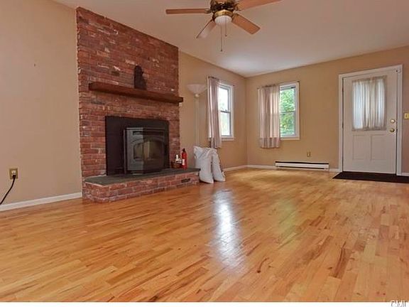 Main Level sunken Family Room has fireplace with pellet stove insert.  It is, indeed, a great energy saver for heating purposes.