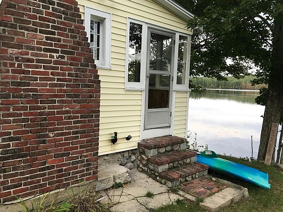 view of the lake and side door to porch