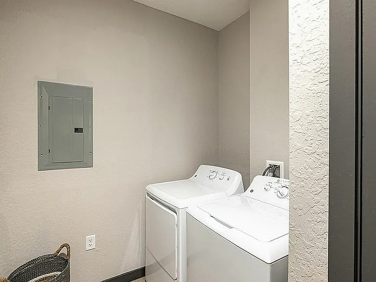 Experience the convenience of an in-unit laundry with this sleek and organized setup.
