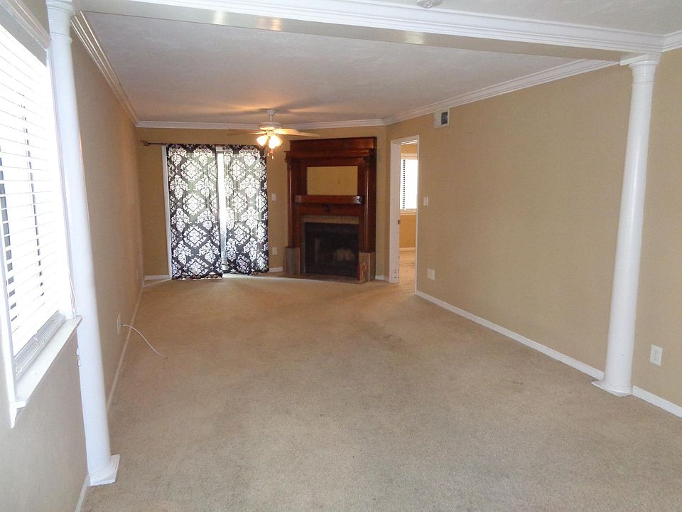 Family Room separated from formal Dining Area by decorative columns and beam. Crown moulding throughout.