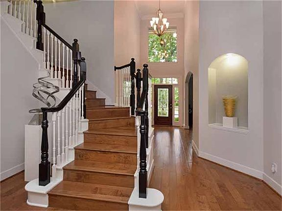 Gorgeous Hand Scraped Hardwoods Wrap all the Way up the Stairs. New Brushed Nickel Light in the Foye
