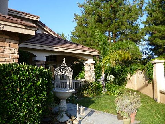 Home is unequally surrounded by a stucco wall with walking path on the side of the home and behind the home giving you extra privacy with no neighbors behind you.