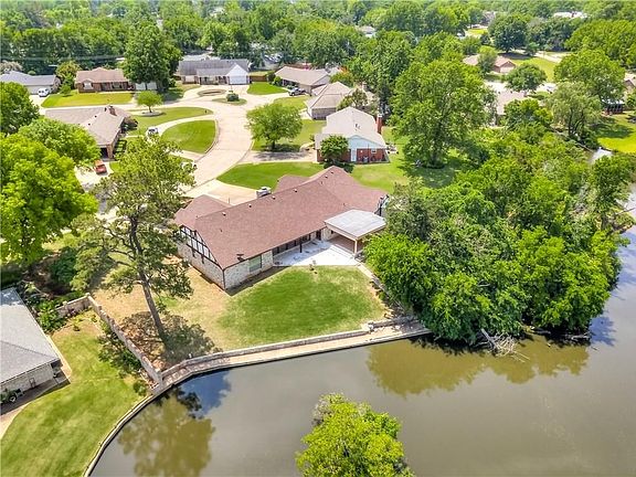 View of back yard and fishing ledge along pond.