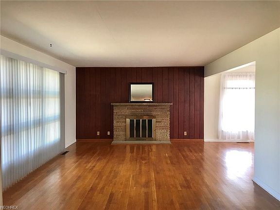 Beautiful hardwood floors!! The gas fireplace is accented by the gorgeous cherry paneling.