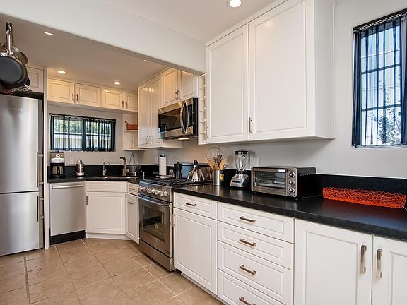 Kitchen with new appliances, honed granite countertops and c