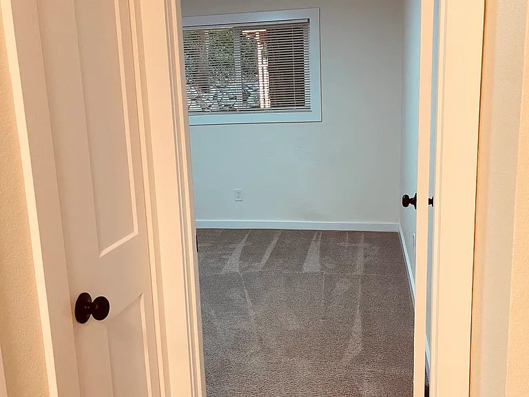 Master bedroom looking out to back yard-trees and greenery.