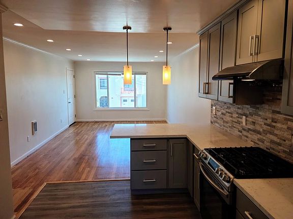 Kitchen facing the large living room window.