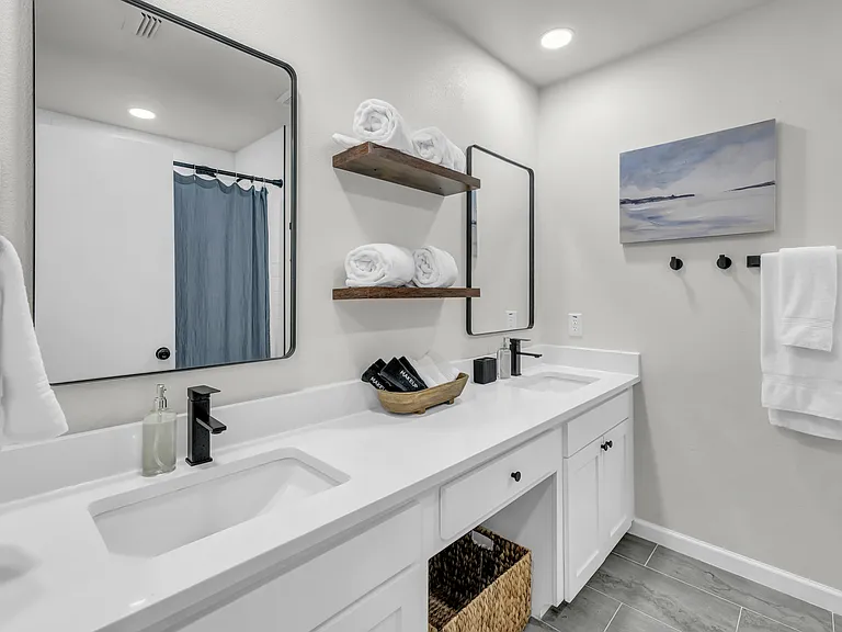 Hallway bathroom with double sinks