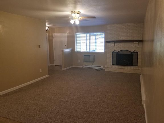Entryway to living room with A/C and fireplace