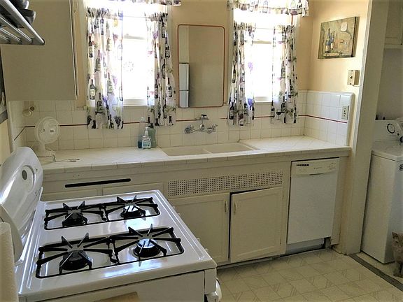 This is the kitchen. Note the mirror above the sink. Because this is a one bathroom place, I sometimes use this area to along my significant other the master bath, so you can store some personals in the medicine cabinet.