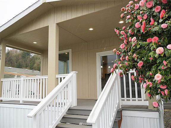 Covered trex deck w/lighting off living area.