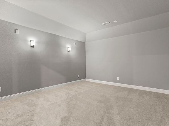 Media room in the Monet home plan by Trophy Signature Homes - REPRESENTATIVE PHOTO