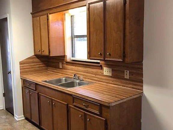 Kitchen has a window that looks out to the backyard.