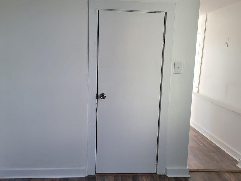 Hall from living room into space that can be used as a dining room, dressing room, study or multipurpose use. That is the door to the bathroom