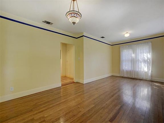 Front room. Beautiful floors. Dining room to left