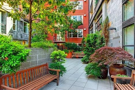 Private landscaped courtyard with seating areas for residents