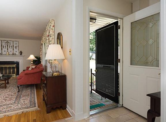 Beautiful front door opens onto a tiled foyer