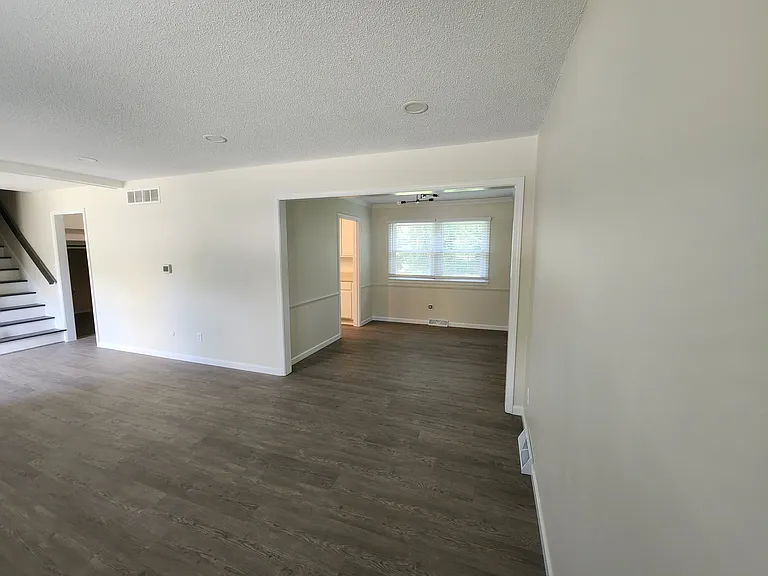 Living room and Dining Room. (stairway and both entry ways to kitchen are visable)
