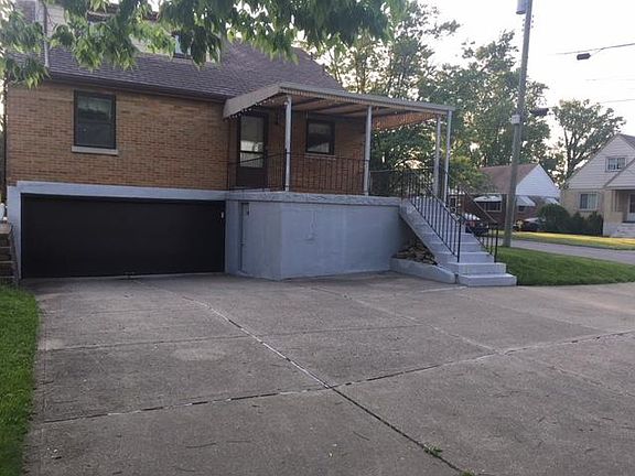 Back of home with driveway 