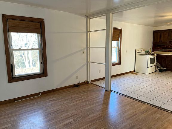 In living room looking toward kitchen with electric stove
