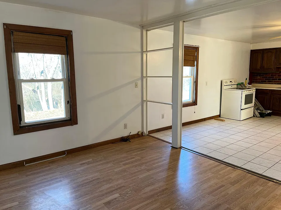 In living room looking toward kitchen with electric stove