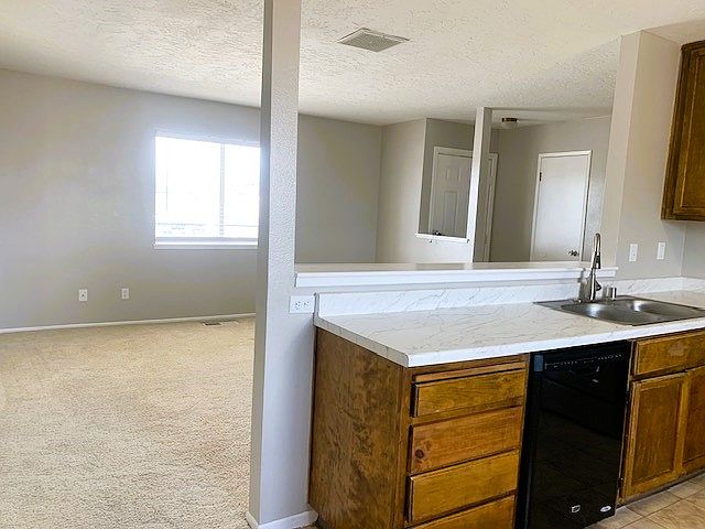 Kitchen comes equip with dishwasher, gas stove, garbage disposal, and refrigerator.