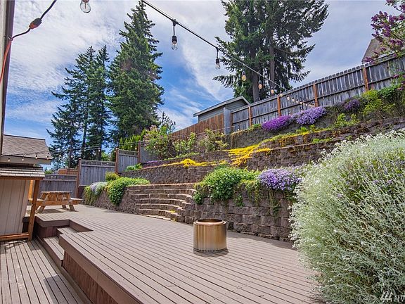 Amazing terraced back yard with lots of deck for outdoor entertaining! Fully fenced & private. All landscaping is set on drip lines for low maintenance beauty. 