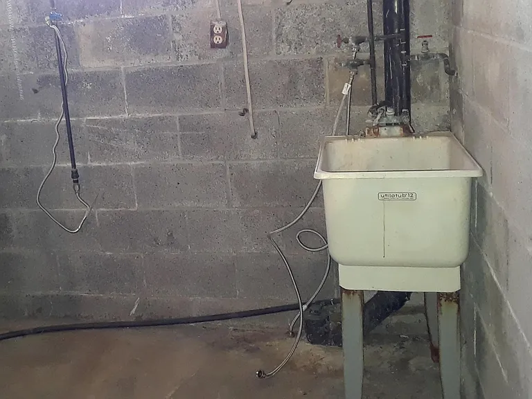 Laundry area with washer/dryer hook-up and utility sink