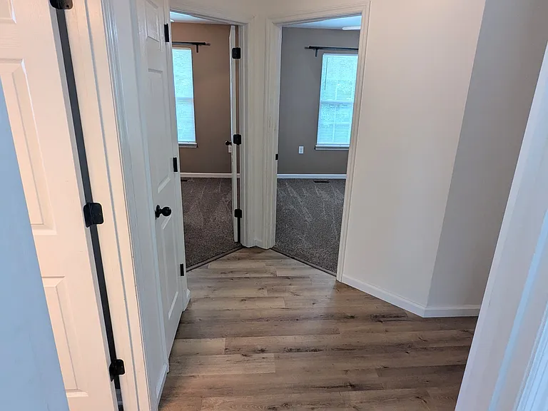 Upstairs hall-- left to right: hall bathroom, linen closet, bedroom #2, bedroom #3