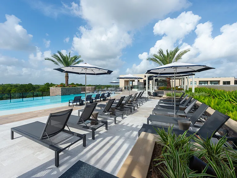 Chairs and umbrellas by the water.