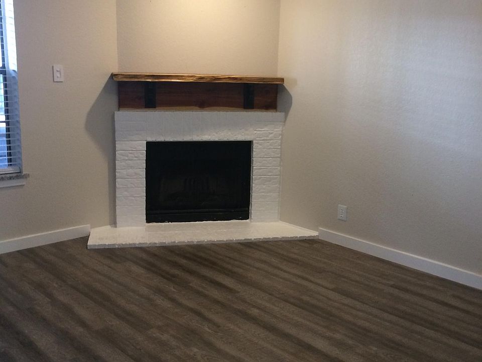 Living room with wood burning fireplace & red cedar mantle. Wood blinds & ceiling fan. Luxury vinyl flooring. Very roomy and comfortable space.